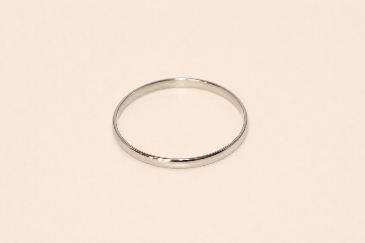 Silver bracelet on a beige background