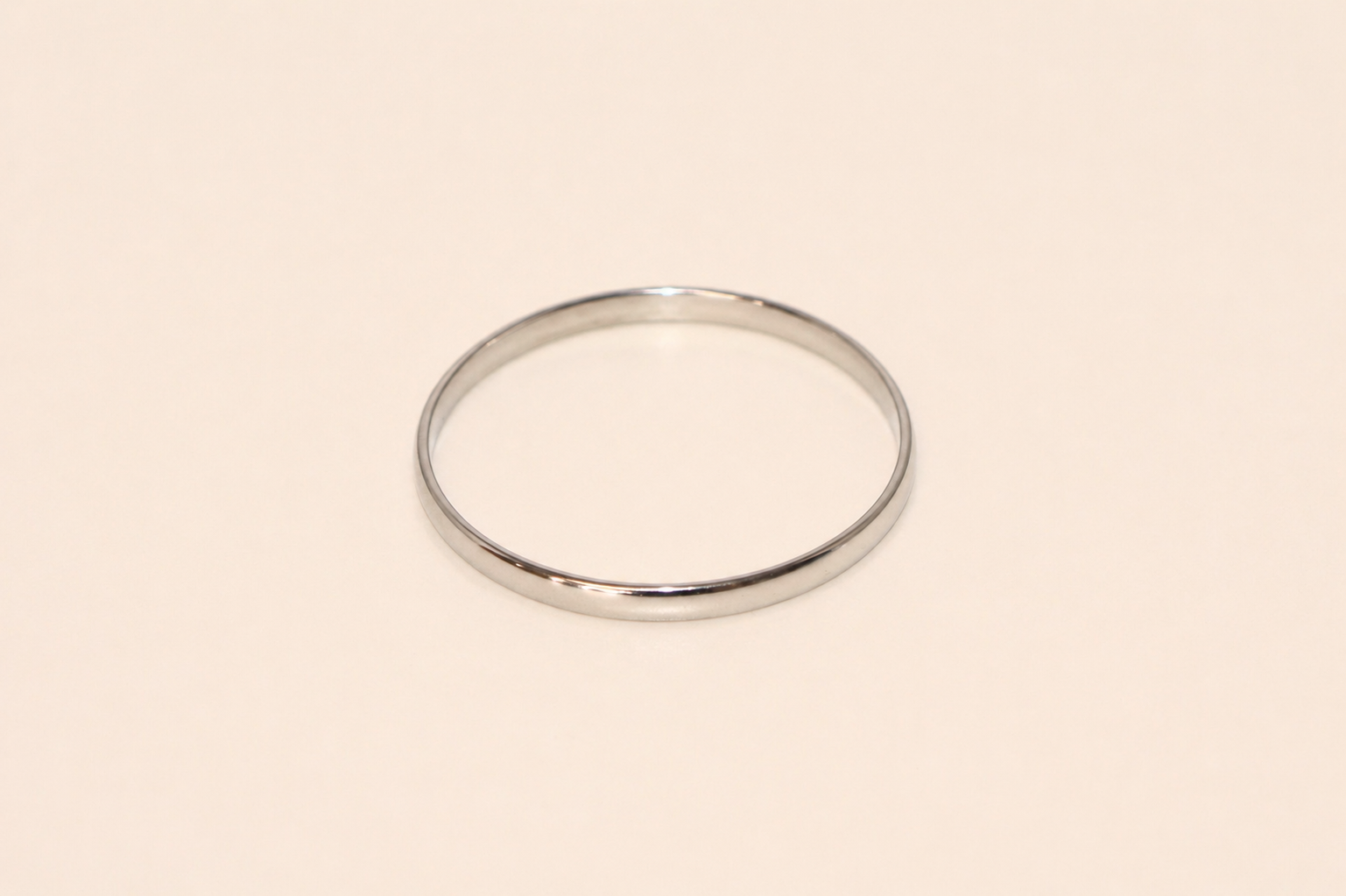 Silver bracelet on a beige background