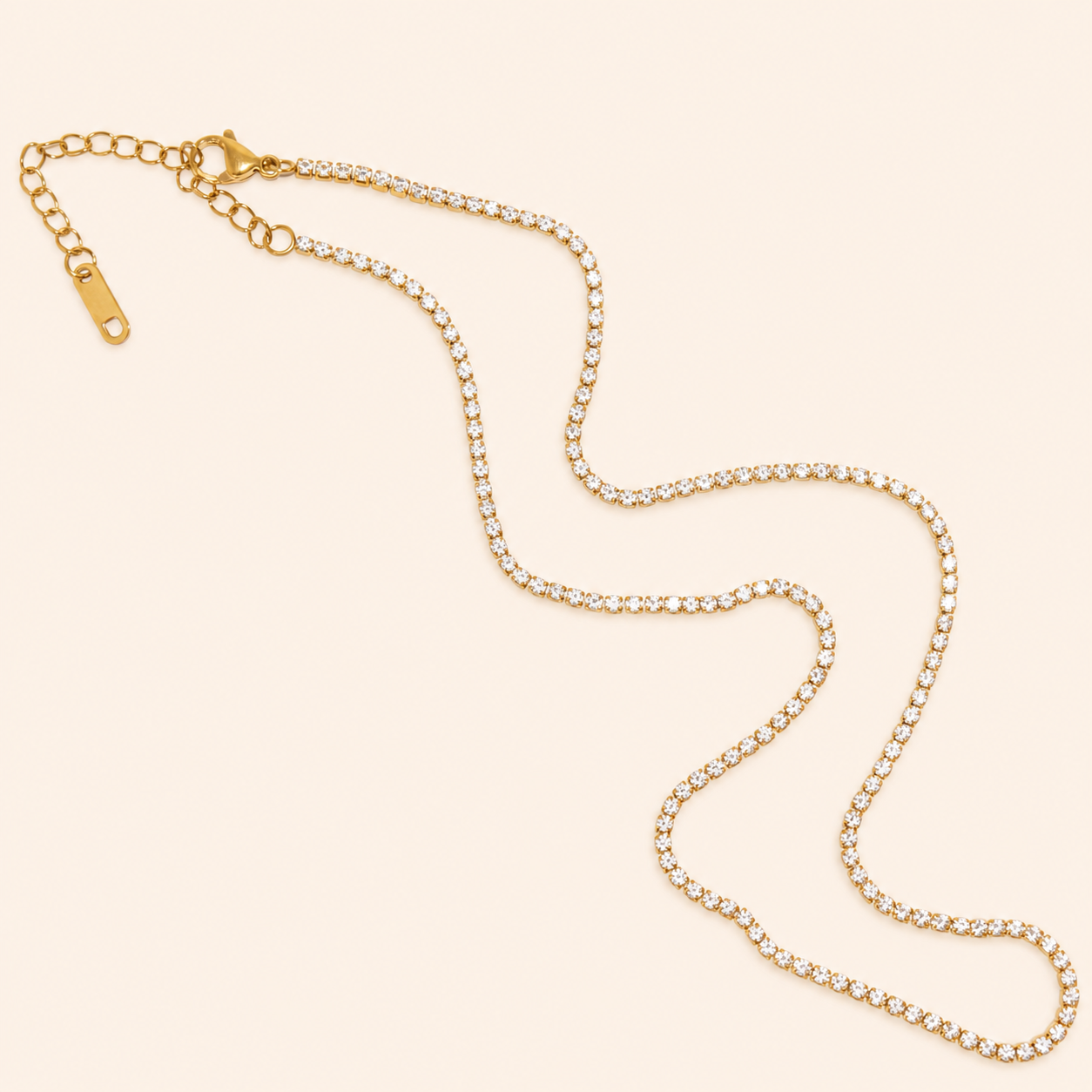 Gold chain necklace on a beige background