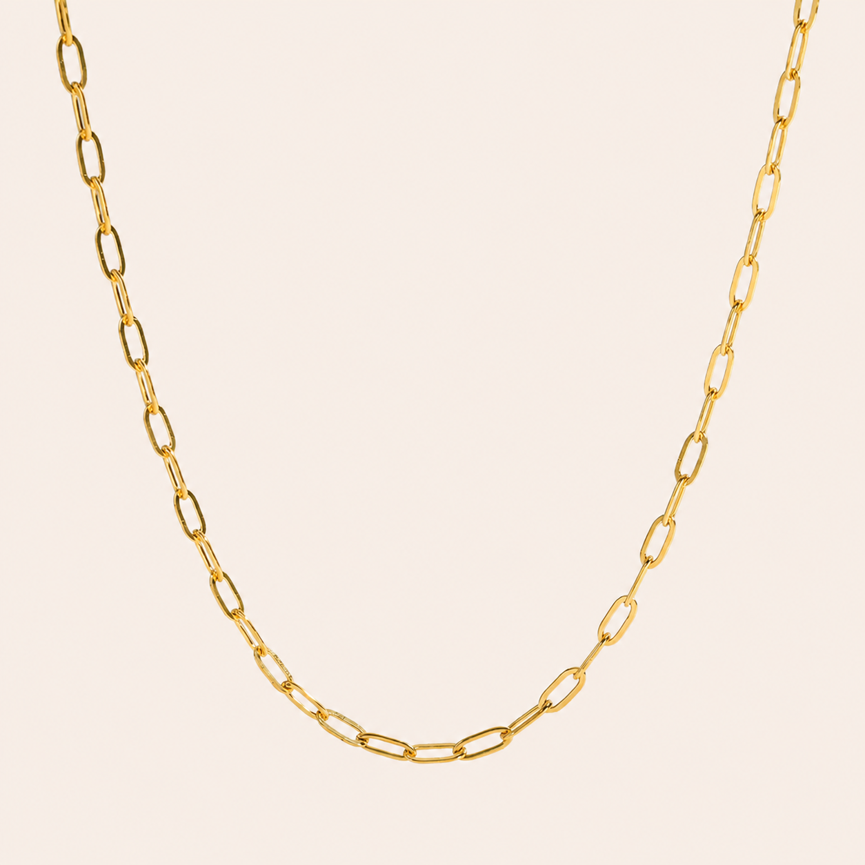 18k PVD Gold plated stainless steel Gold paperclip chain necklace on a beige background