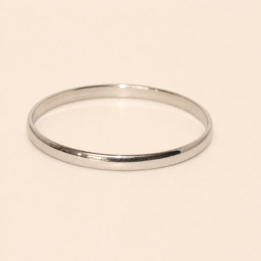 Silver bangle on a beige background