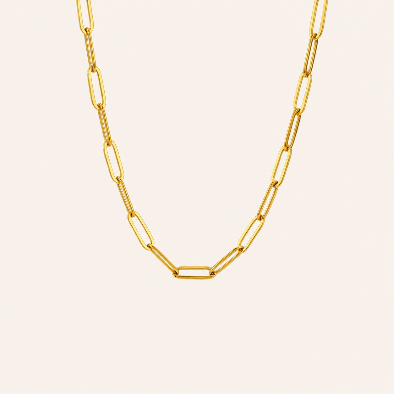 Waterproof Gold paperclip chain necklace on a light beige background